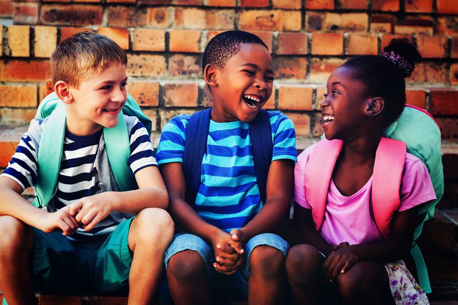 School Insurance - School Age Children Talking Together Outside School