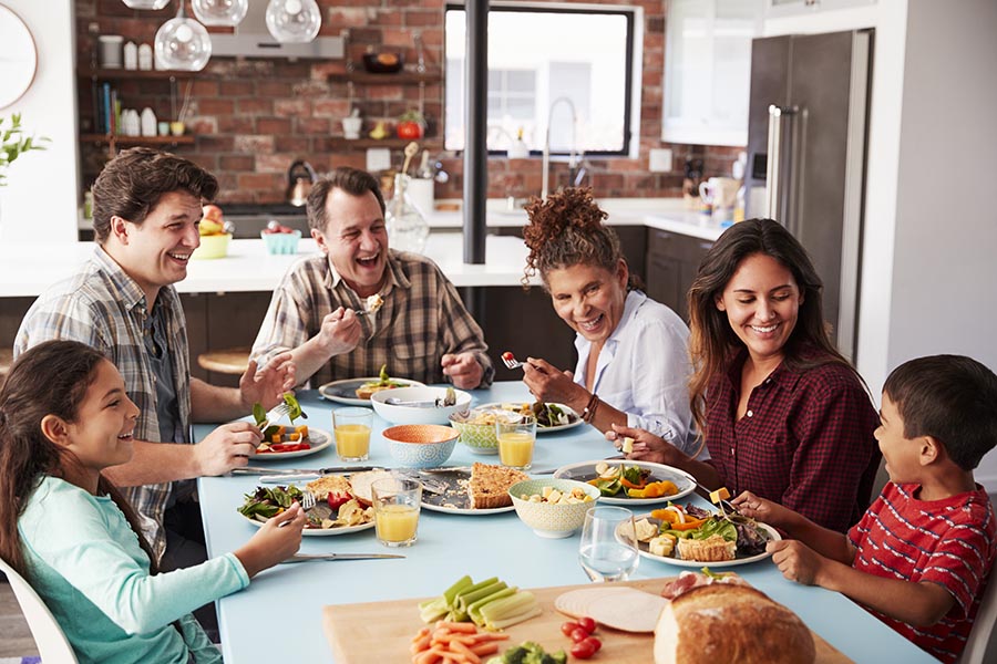 About Our Agency - Multigenerational Family Enjoying Breakfast in Their Home, Laughing Together